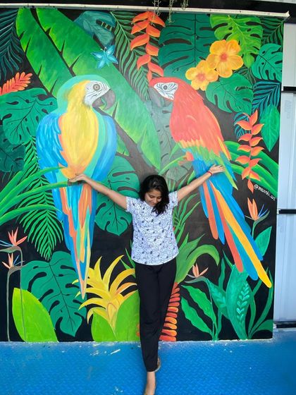 This vibrant tropical mural featuring two large macaw parrots was a joy to create. The bold colors and dense foliage on a black background make for a dramatic and stunning photo point in a restaurant.