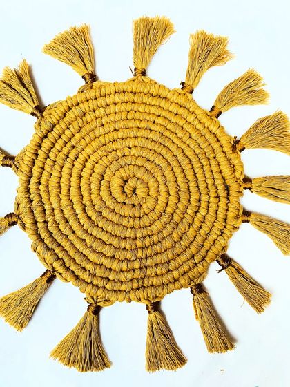 Another look at the intricate spiral weave of the sunburst placemat. This design is not only beautiful but also creates a sturdy, flat surface for your plates or a centerpiece.