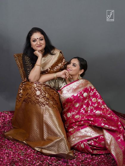 A multi-generational shoot showcasing two women in beautiful Banarasi sarees, creating a heartwarming and elegant brand image.