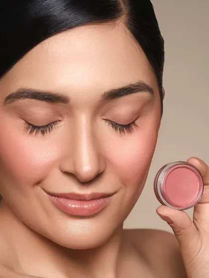 A soft and pretty look showcasing a cream blush. The color is blended seamlessly into the skin for a natural, lit from within effect.