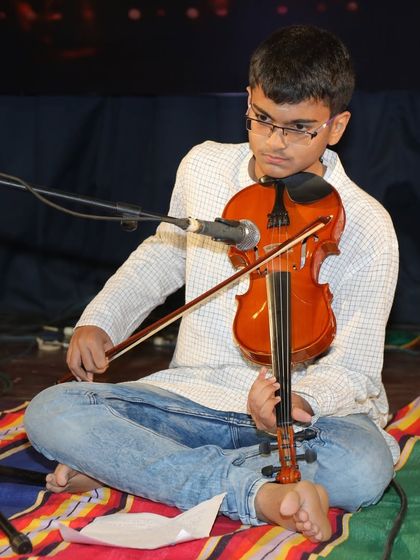 Another angle of Amogh's violin performance, highlighting his graceful bowing technique.