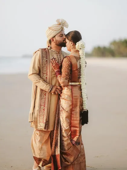 A serene portrait on the beach against the golden hour sun. We guide our couples into poses that feel natural and romantic, capturing the quiet connection between them in stunning destination wedding photography.