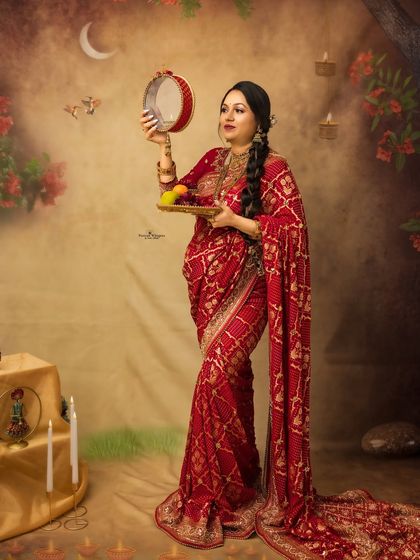 A stunning solo portrait of a mother-to-be performing the Karva Chauth ritual. The intricate details of her saree and the festive setup create a powerful and artistic image.