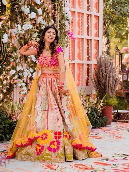 A candid shot of a bride enjoying her solo moment on stage. Her bright smile and colorful lehenga lit up the entire event.