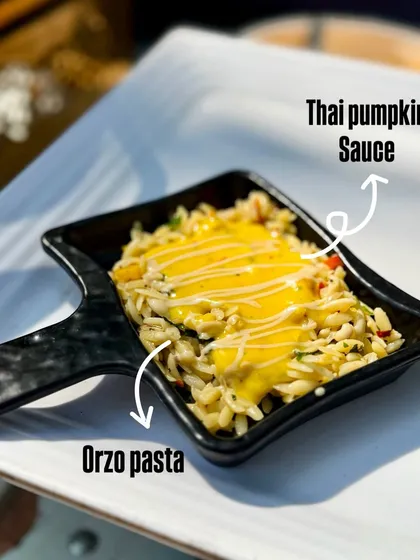 This is my popular Parolina Orzo in Thai pumpkin sauce. The small, rice shaped pasta is cooked with vegetables and coated in a creamy, sweet and savoury pumpkin sauce, offering a unique fusion of Italian and Thai cuisines.