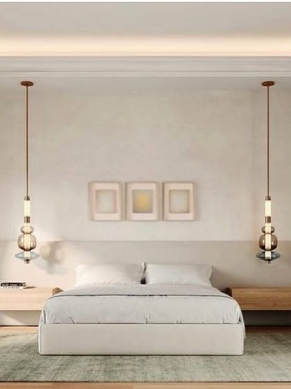 Two Luna pendants serve as chic bedside lighting, their warm glow creating a relaxing and luxurious atmosphere in a modern bedroom.