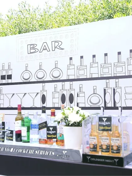 The bar setup for the 'Line Art Carnival', featuring a custom-illustrated backdrop that turns a simple bar into a piece of thematic art.