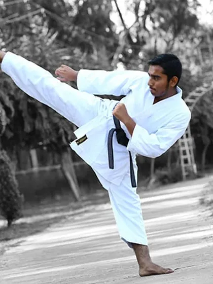 An artistic shot of a high kick, showing the clean lines and form we aim for. Proper technique, developed through practice and conditioning, is at the heart of martial arts.