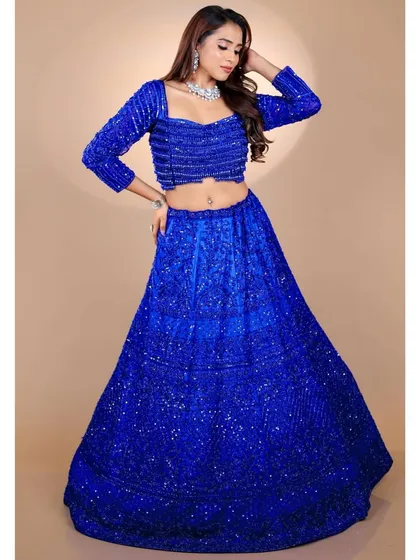 Make a bold and unforgettable entrance with this royal blue lehenga. Fully adorned with sequins, this outfit is designed to sparkle and stand out. It's a fantastic choice for a sangeet or reception where you want to dance the night away.