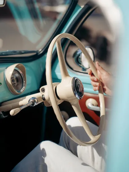 A close-up on the steering wheel of a vintage car. This detail-oriented shot evokes a strong sense of nostalgia and classic style, a throwback to a different era of Mumbai's streets.