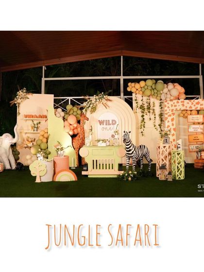 Here is the full view of our pastel jungle safari setup. We combined soft greens and pinks with classic animal prints and props like a friendly zebra and a safari-style dessert cart to create a unique 'Wild One' party.