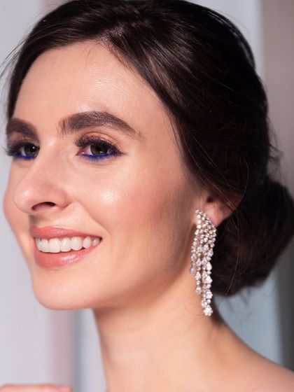 A pop of electric blue liner adds a modern twist to this otherwise classic and elegant engagement look.