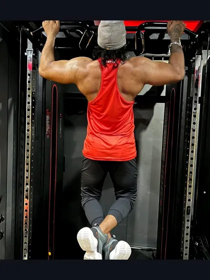 Building a strong back is the foundation of a powerful physique. This is a shot of me during a pull-up, a key exercise we use for developing lats and upper back strength.