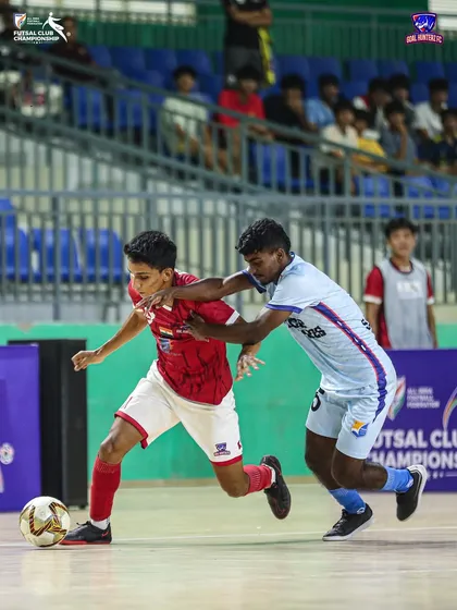 A young player taking on a defender in the quarter-final.