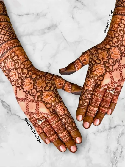 An intricate full back-hand design combining a lotus-and-vine grid pattern with detailed finger work. This is a stunning choice for a bride, bridesmaid, or close family member.