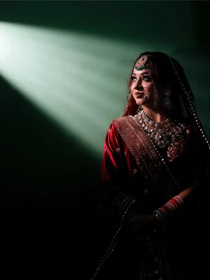 I love playing with light to create something truly magical. This dramatic bridal portrait uses a single beam of light to highlight the bride's anticipation and elegance just moments before her ceremony.
