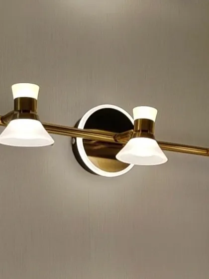 A three-headed vanity or picture light with a modern design. The adjustable heads allow you to direct light exactly where you need it.