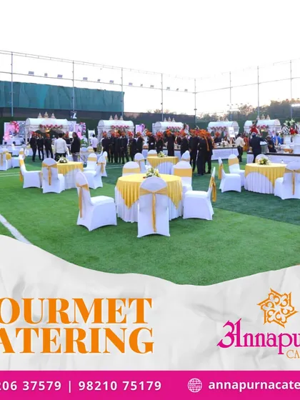 A beautiful outdoor event setup on an artificial turf ground. Our gourmet catering services are perfect for creating a sophisticated atmosphere in any location.