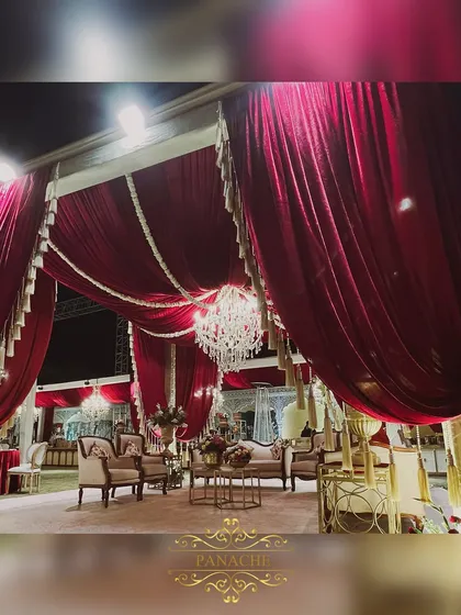 A wider view of the royal lounge, showcasing how we use dramatic draping and crystal chandeliers to transform a simple lawn into a luxurious extension of the main event space.