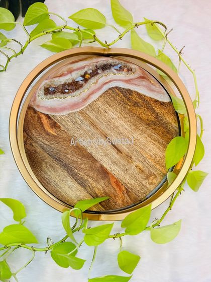 A top-down view of the tray, framed by lush green leaves. This piece truly brings a touch of nature indoors.