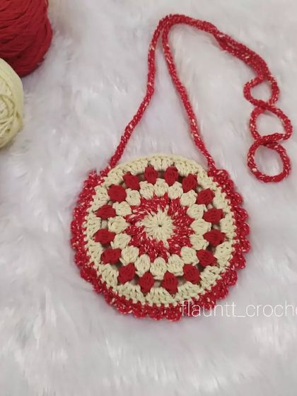 The Merry Bag on its own, next to the yarn I used to make it. The granny square design is classic, and the sparkly red yarn adds a bit of fun.