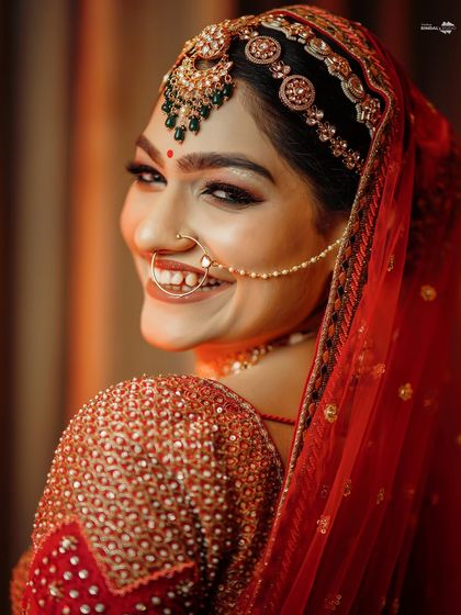 A radiant bridal portrait. The bride's joyful, beaming smile is the highlight of this beautiful close-up shot.