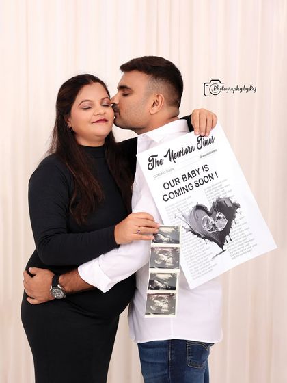 A creative pregnancy announcement photo with the couple holding custom newspapers. A fun and unique way to share the news.