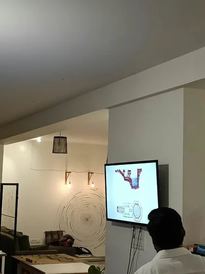 A presenter at our 'Reading Series' event, sharing insights on a screen. Our studio is a place for intellectual exchange and creative inspiration.