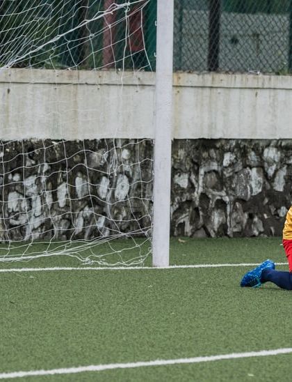 A young goalkeeper makes a save. We teach proper technique and bravery to our keepers from a young age.