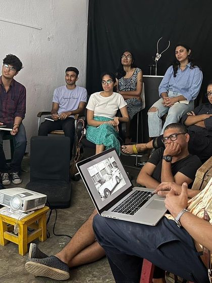 Participants and instructors in a critique session for the OSCH photography project. We foster an environment of open discussion and learning, where artists can share their work and grow together.