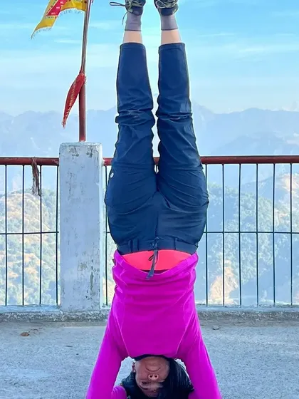 Holding a steady headstand in Rishikesh. This posture requires core strength, shoulder stability, and a calm, focused mind.
