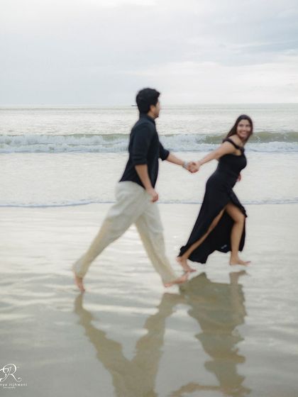 The reflection on the wet sand creates a dreamy, artistic effect in this motion shot. It adds another layer to the story of their walk along the beach.