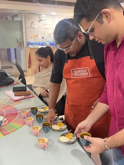 Our trainer guiding participants through the tasting process, explaining what to look for when pairing coffee with food.