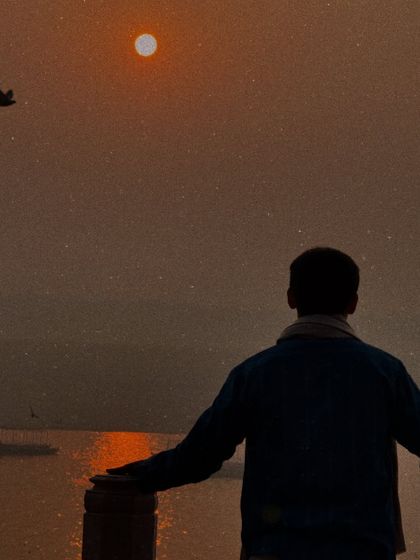Looking out over the water at dusk. This image reflects my intention to bring the life-transforming potential of yoga to more people, focusing on inner wellbeing over superficial postures.
