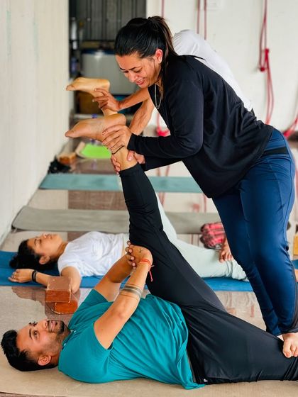 Partner work is a great way to build trust and go deeper into stretches. Here, a student assists another with a supine hamstring stretch.