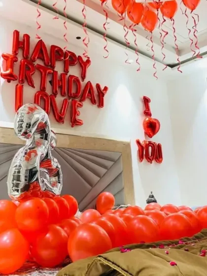 A close-up of the bed decoration, with 'I Love You' and number '25' foil balloons.