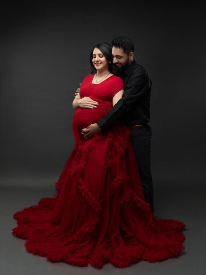 A tender embrace from behind, with both of their hands on the baby bump. A perfect portrait of unity and anticipation.