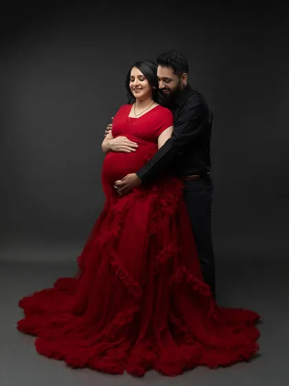 A tender embrace from behind, with both of their hands on the baby bump. A perfect portrait of unity and anticipation.
