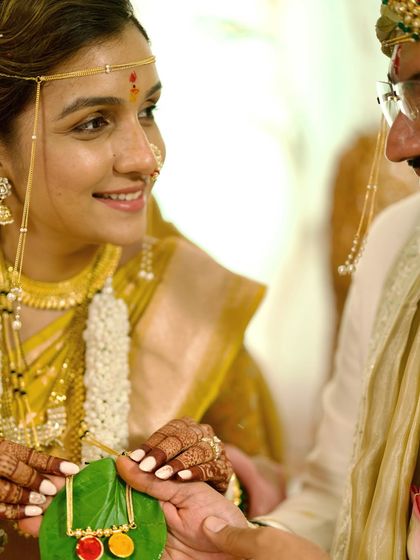 A close-up of a significant ritual during a Marathi wedding. The bride's gentle smile and the focus on the traditional elements showcase our attention to detail in capturing cultural ceremonies authentically.