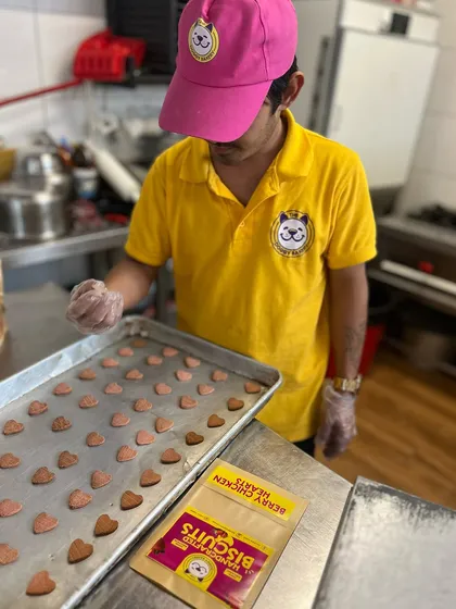 My baker is carefully arranging Berry Chicken Hearts on a tray before they go into the oven. Every treat is handcrafted and inspected for quality.