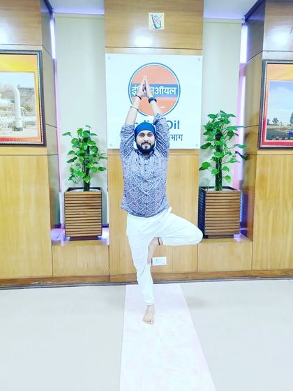 Holding Tree Pose at the IOCL office. This pose is excellent for improving balance and concentration, which is very beneficial in a work environment.