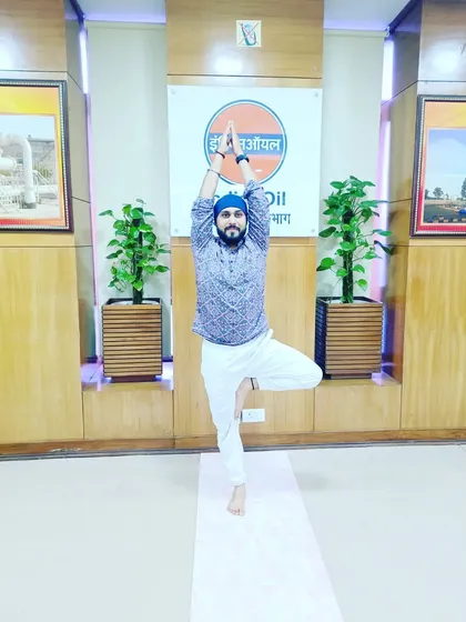 Holding Tree Pose at the IOCL office. This pose is excellent for improving balance and concentration, which is very beneficial in a work environment.