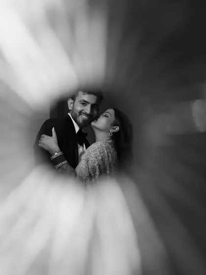 A creative ring-of-fire effect used to frame the couple in a loving embrace. This artistic technique makes for a unique and memorable black and white portrait.