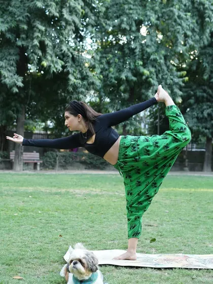 A side view of the Natarajasana pose, showing the deep backbend and stretch. My little dog often joins my outdoor practice, adding to the joy.