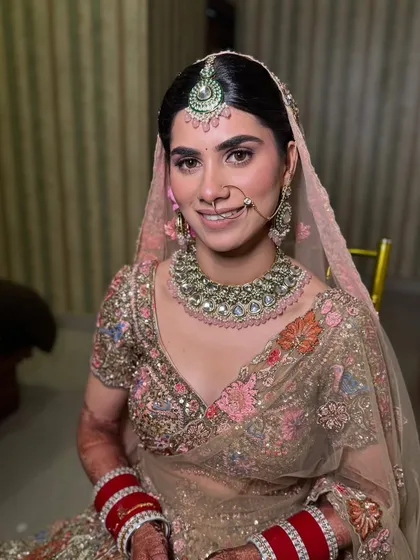 A beautiful portrait of Khushi. Her makeup is soft and luminous, with a focus on natural-looking skin and gentle pink tones that perfectly match her elegant pastel outfit.