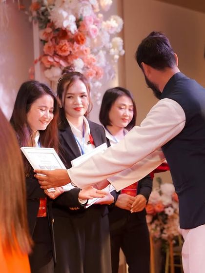 Presenting certificates of completion at an international yoga event. Recognizing the hard work and dedication of students is an important part of their journey as future teachers.