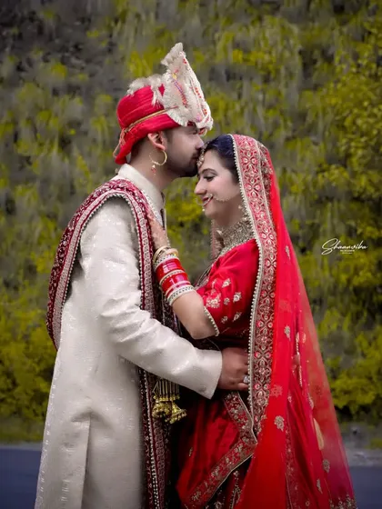 A tender moment from a Himachali wedding shoot. Capturing the quiet connection between a couple is what makes a wedding album special. This outdoor portrait highlights the beautiful traditional attire against a natural green background.