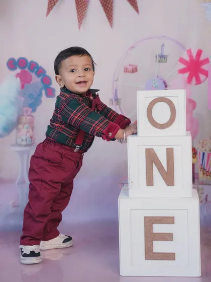 Standing tall and proud next to his birthday blocks. This pose is great for showing off his new standing skills.