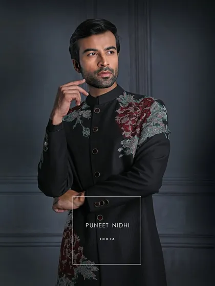 Beyond fabric, this black achkan is a portrait of tradition in modern light. Vintage roses whisper of elegance eternal, created for the man who defines class by the legacy he carries.