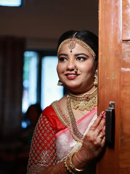 A candid moment of the bride, giving a peek of her beautiful choker and nose ring.